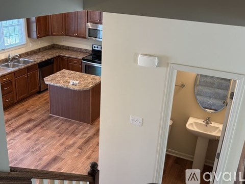 A kitchen with wooden cabinets and a granite island.