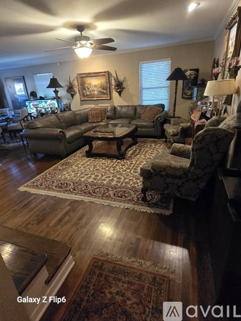 A living room with a rug and a couch.