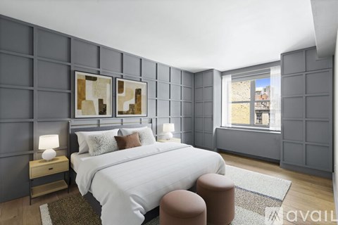 A bedroom with a large bed and a window overlooking a cityscape.