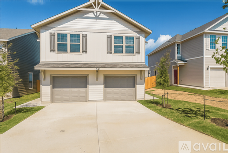 A two-story house with a garage is for sale.