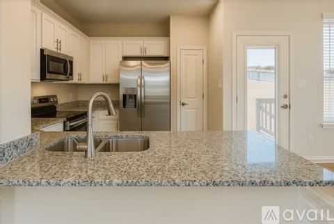 A kitchen with granite countertops and stainless steel appliances.