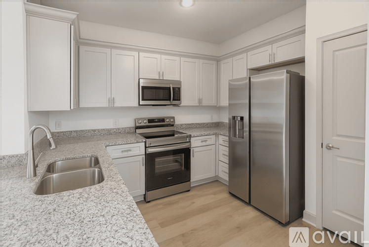 A kitchen with a sink, stove, and refrigerator.