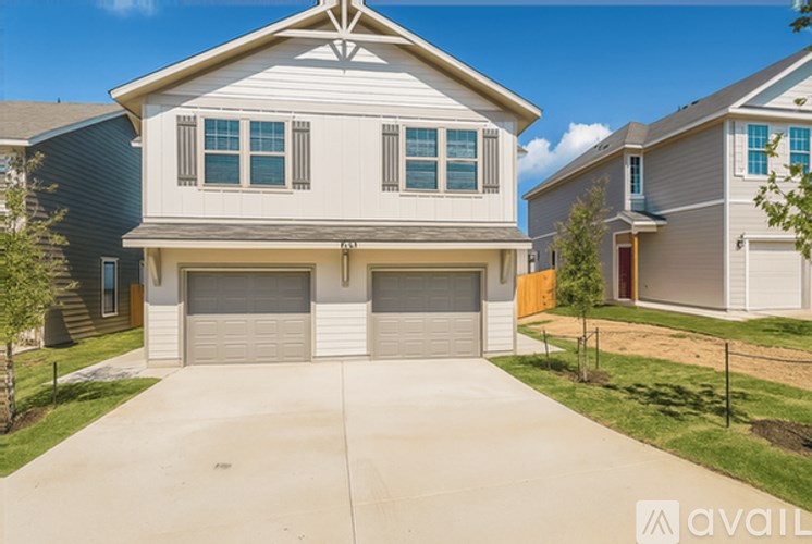 A two-story house with a garage is for sale.