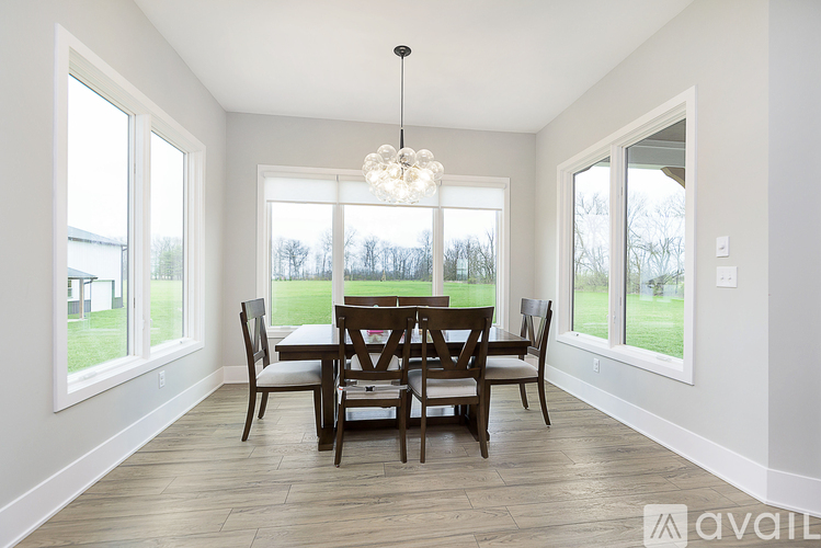 A dining room with a table set for four.