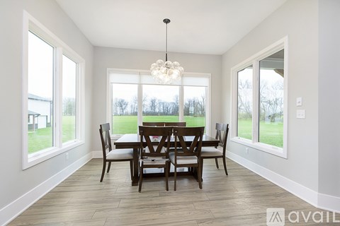 A dining room with a table set for four.