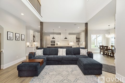 A living room with a grey sectional sofa and a rug.