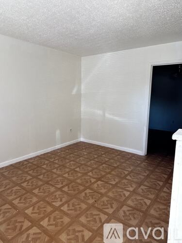A room with a brown patterned floor and white walls.