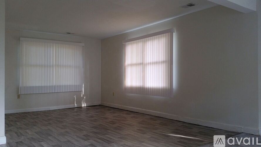 A room with a window and a wall with a logo on it.