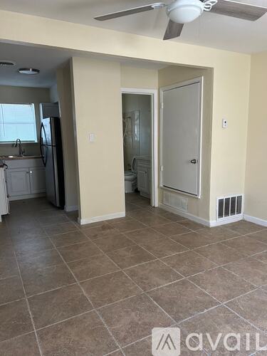 A room with a fan and a tile floor.