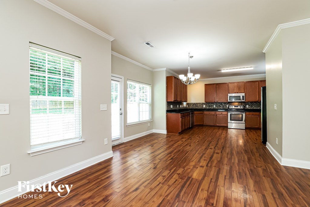A spacious kitchen with wooden floors and a central island.
