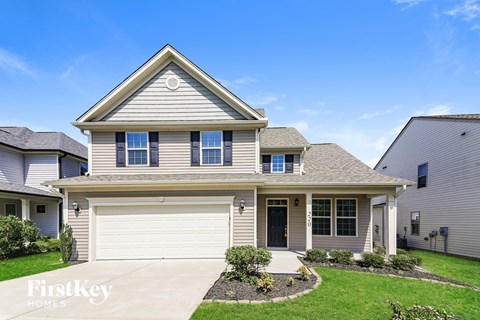 A house with a garage is for sale.