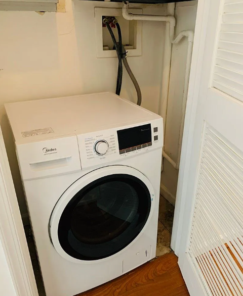 A white washing machine and dryer in a small laundry room.