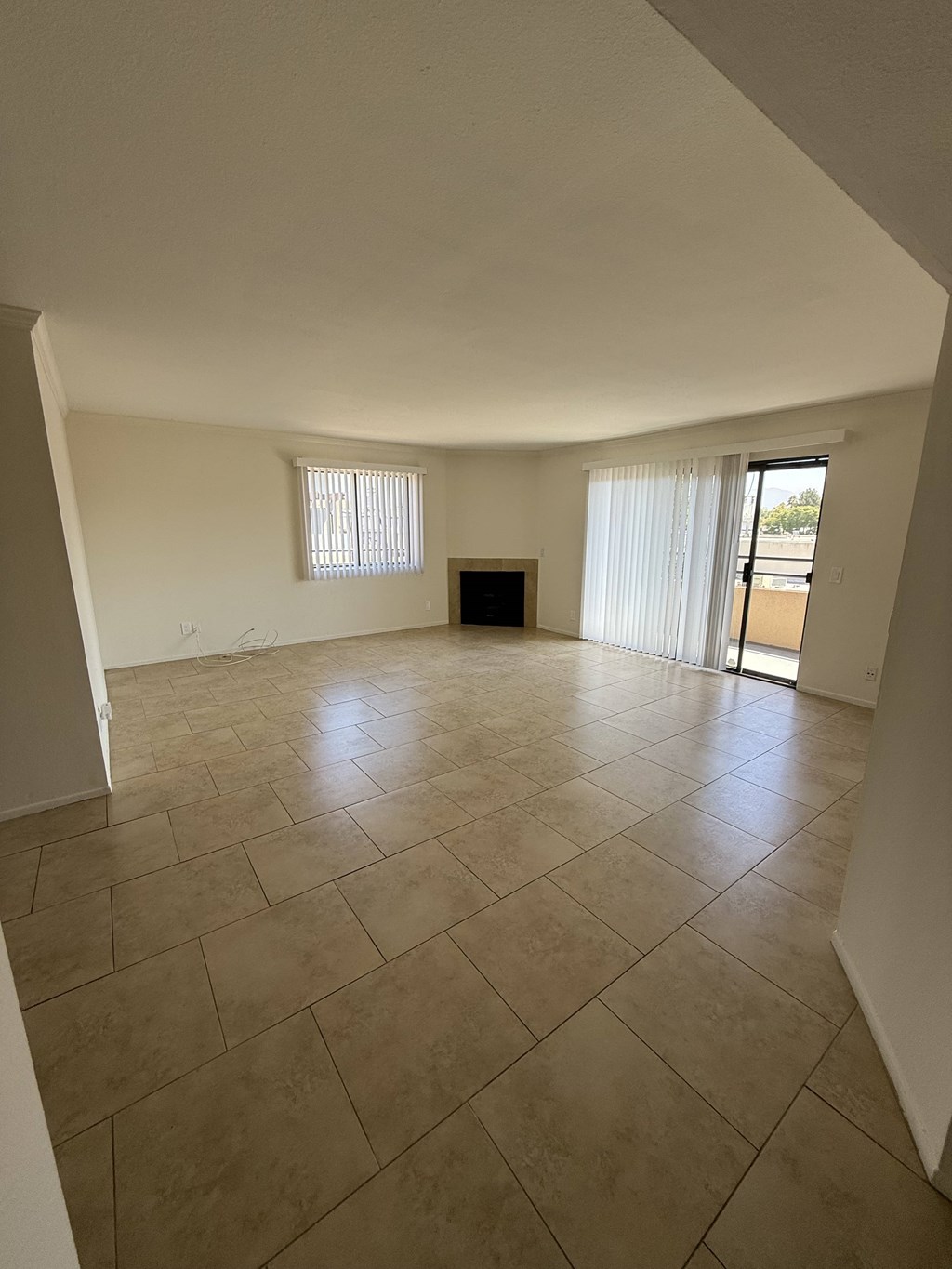 A room with a tiled floor and a fireplace.