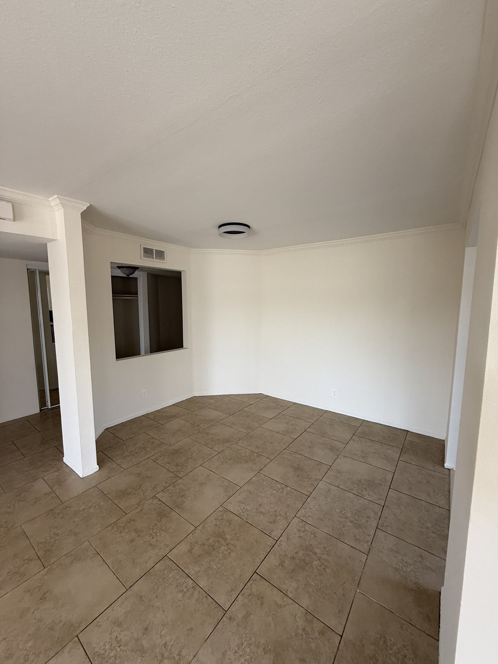 A room with a tiled floor and a window.