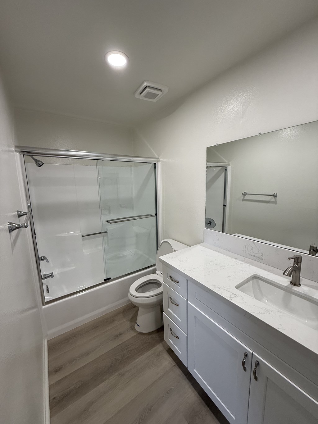 A white bathroom with a toilet and sink.