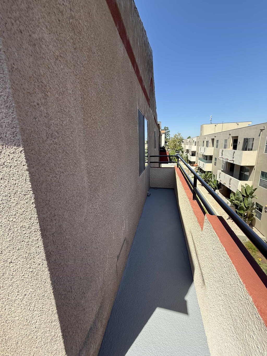 A narrow concrete pathway between two buildings.