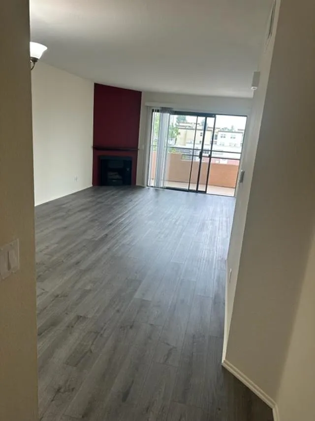 A room with a fireplace and sliding glass doors.