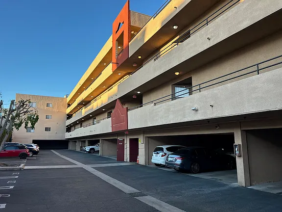 A parking garage with cars parked in it.