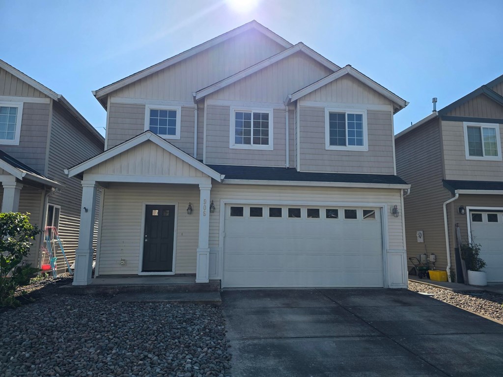 A house with a garage door in the front.