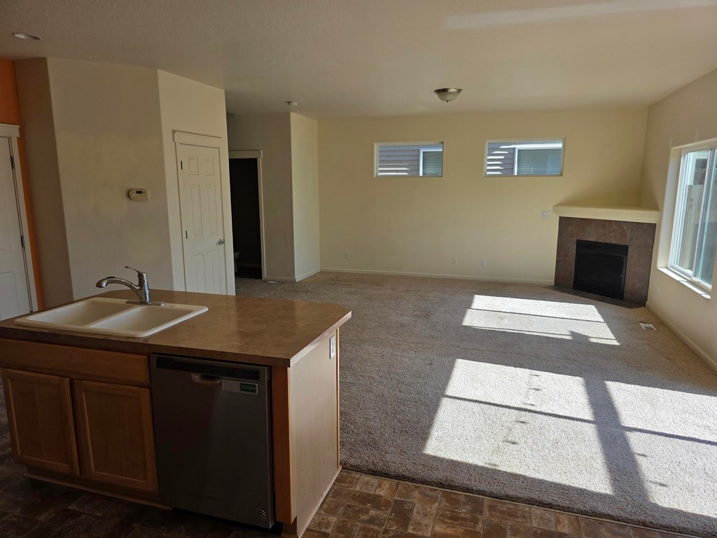 A kitchen with a sink and a dishwasher.
