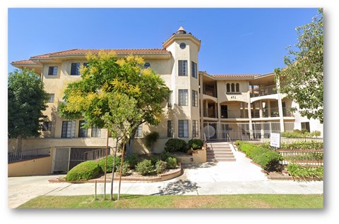 A large house with a staircase leading to the front door.