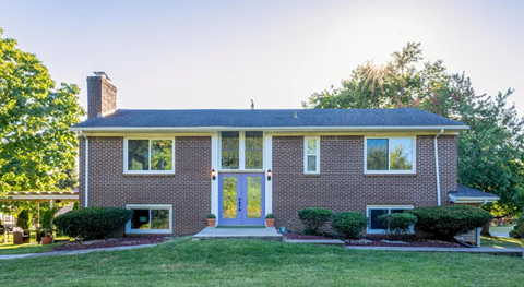 A house with a brick facade and a white door.