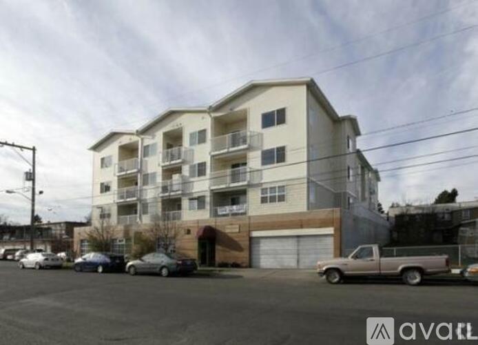 A large apartment building with a parking lot in front of it.