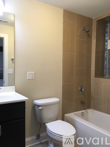 A bathroom with a toilet, sink, and tub.