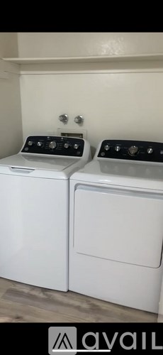 A white toilet sits next to a sink in a small bathroom.