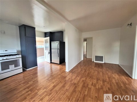 A kitchen with a stove top oven and a refrigerator.