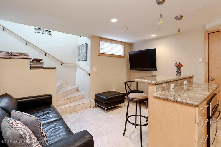 A living room with a bar and a couch.