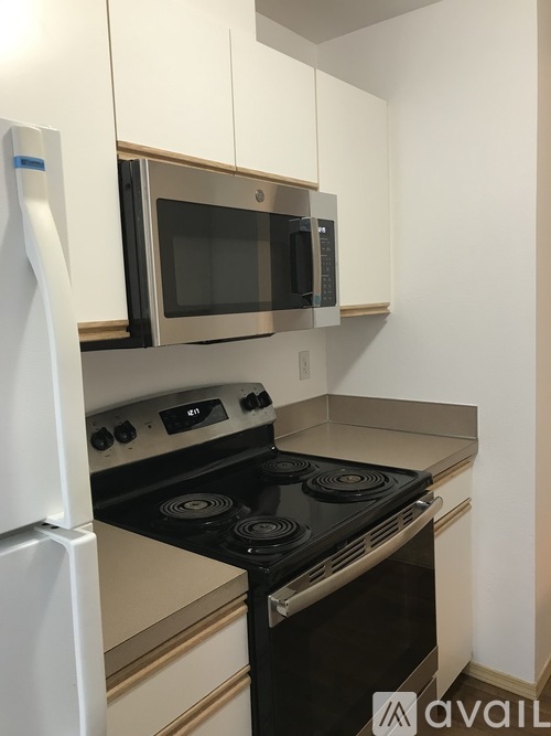 A kitchen with a stove, oven, and microwave.
