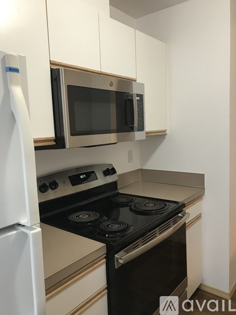 A kitchen with a stove, oven, and microwave.