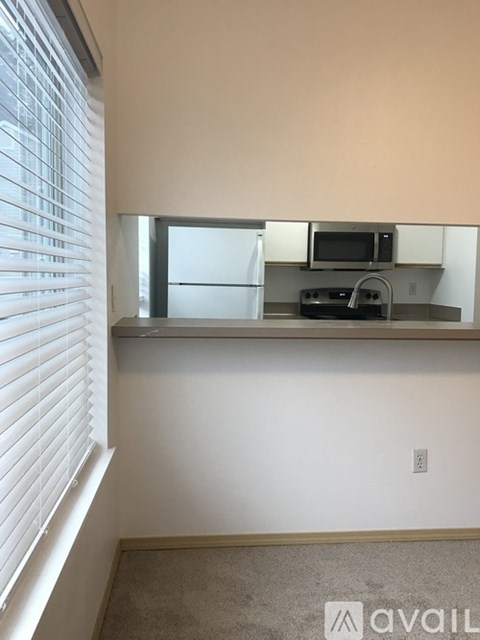 A kitchen area with a microwave, oven, and sink.