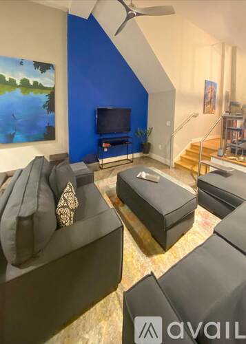 A living room with a blue wall and a television.