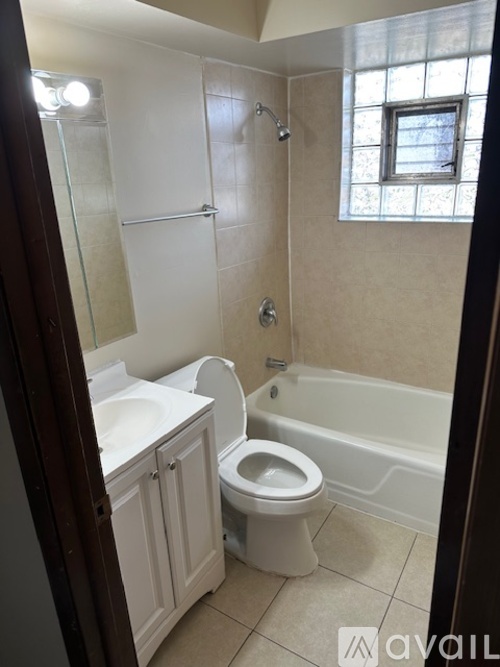 A bathroom with a toilet, sink, and bathtub.