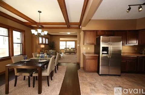 A kitchen with a table and chairs in the middle of the room.