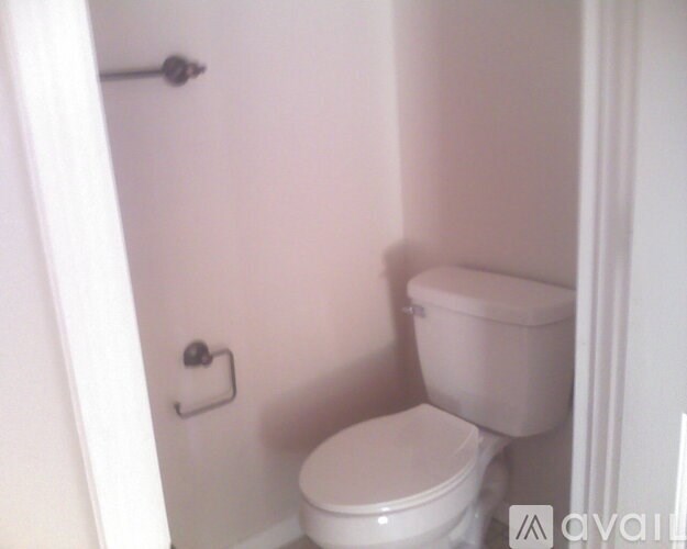 A white toilet in a small bathroom.