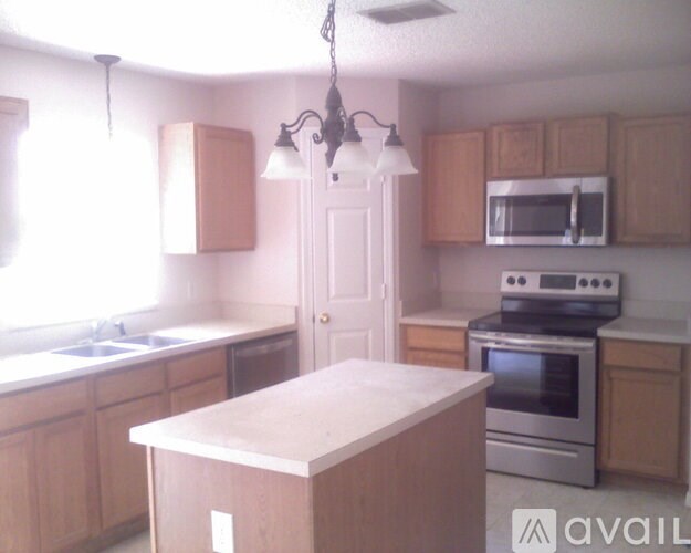 A kitchen with wooden cabinets and a white island.