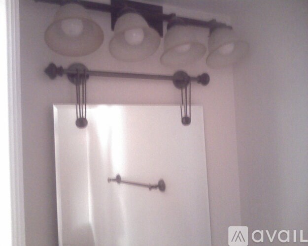 A white shower curtain hanging in a bathroom.