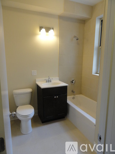 A bathroom with a toilet, sink, and bathtub.