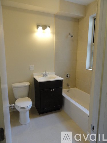 A bathroom with a toilet, sink, and bathtub.