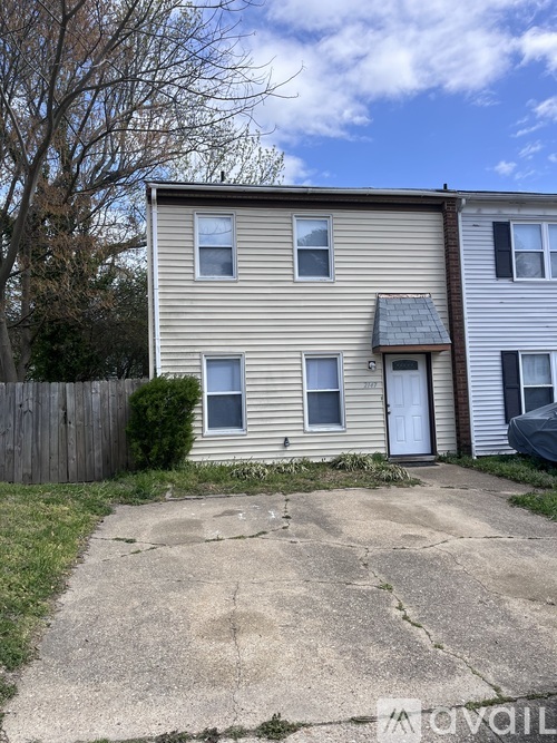 A house with a white siding and a brown roof is for sale.