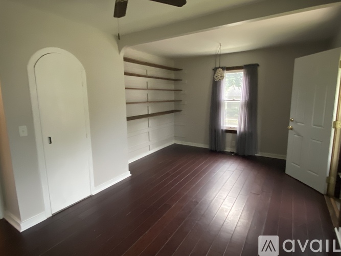 A room with wooden floors and white walls.