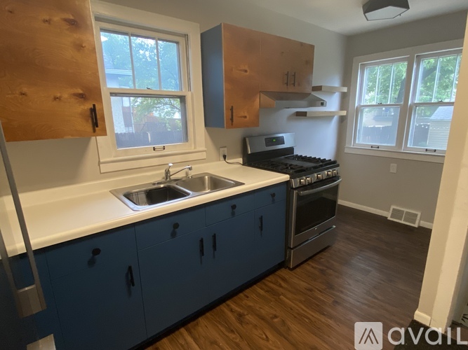 A kitchen with blue cabinets and a white countertop.