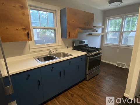 A kitchen with blue cabinets and a white countertop.