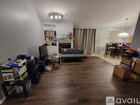 A living room with a grey couch and a television.