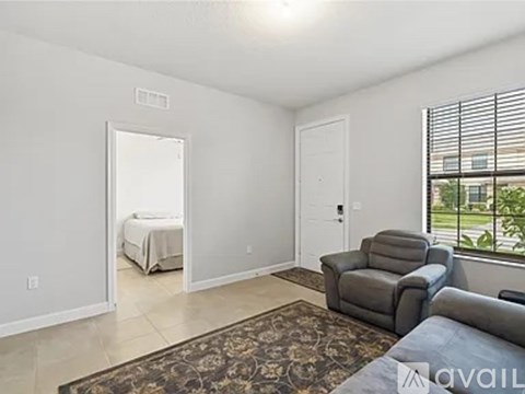 A bedroom with a bed and a couch in a living room.