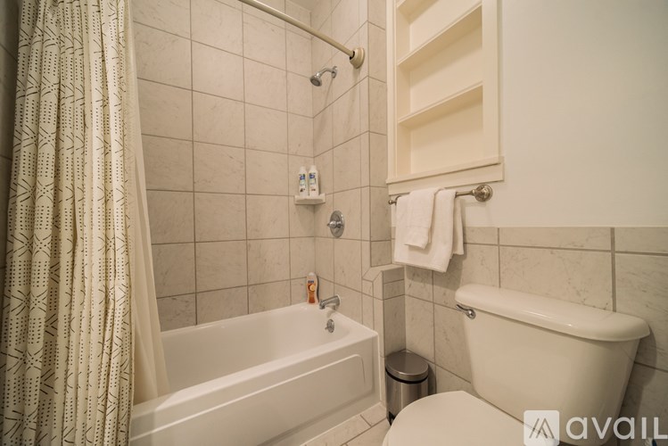 A bathroom with a white tub and toilet.