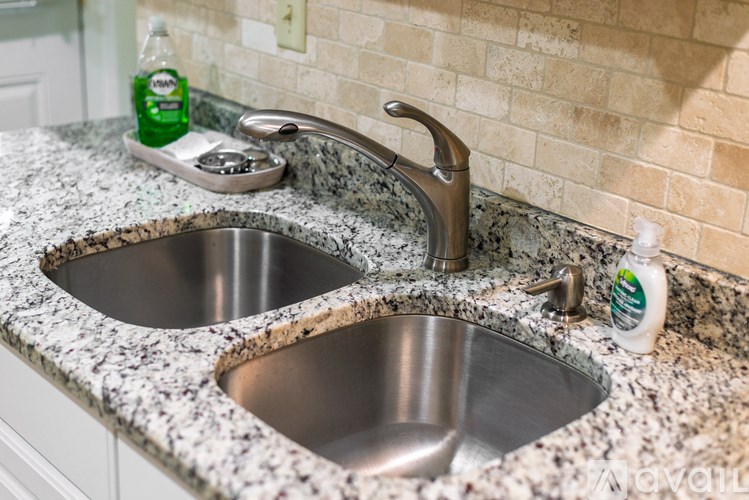 A bathroom sink with a granite counter top.